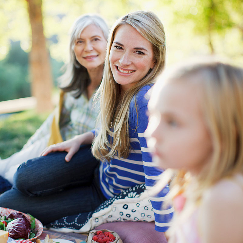 Three generations of women picnicking
